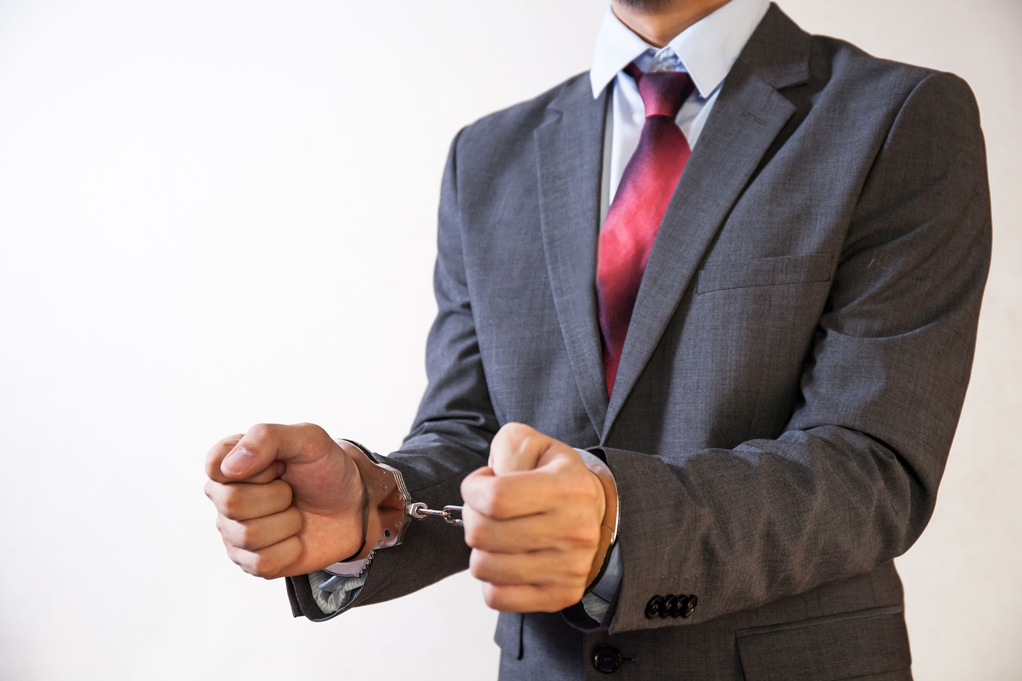 Business man hand-cuffed and being arrested